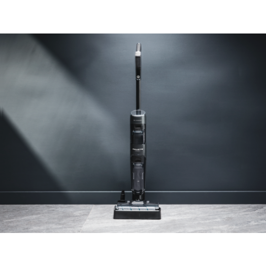 Tefal X-Clean 4 wet and dry vacuum cleaning a wooden floor, showing a transition from heavy dirt to a clean surface.